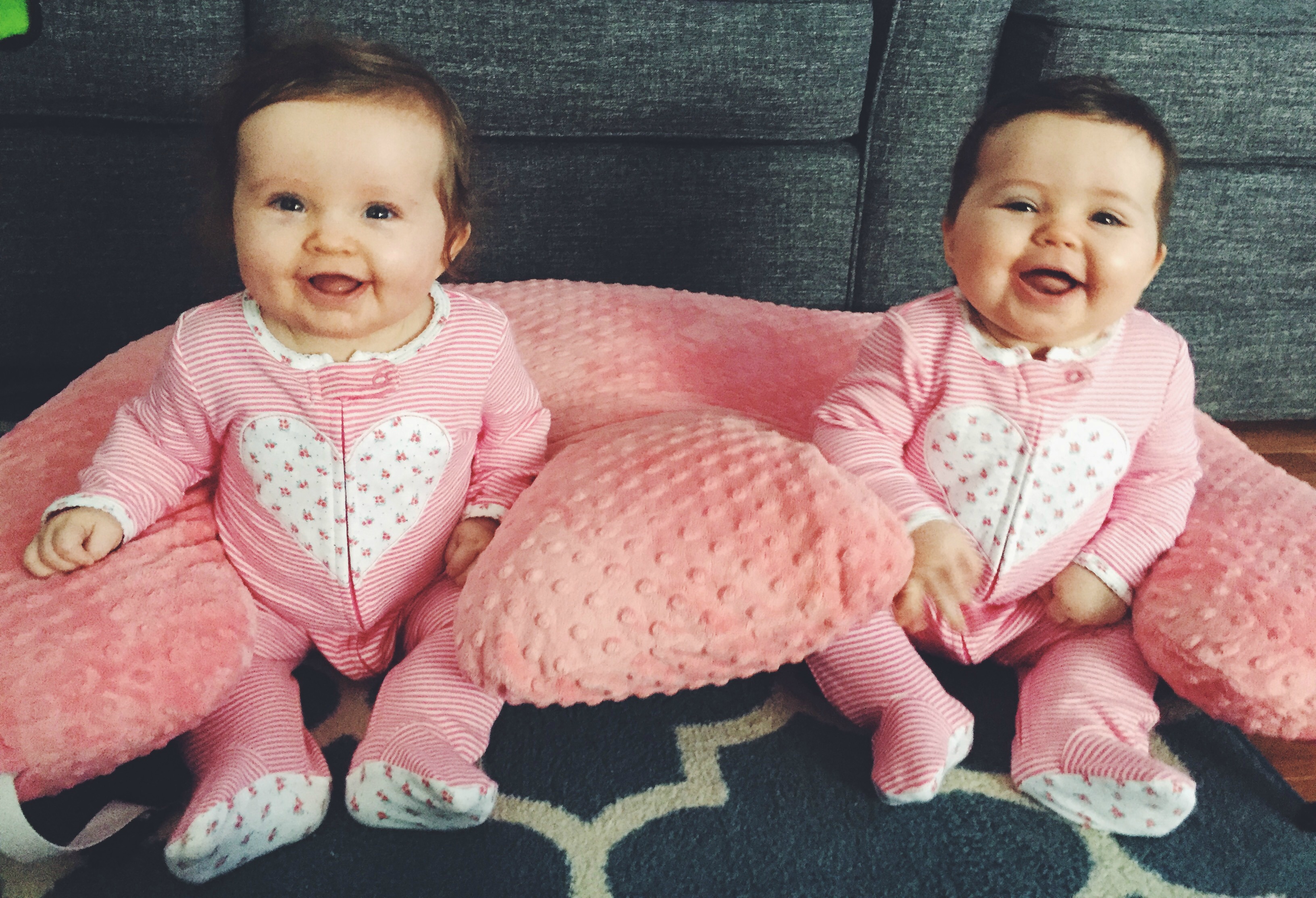 Adorable twin girls in matching heart pajamas perfect for Valentine's Day! #valentinesday #twins #babyfashion